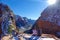 LENS FLARE: Hiker couple sits together on a ledge and observes the wintry canyon