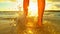 LENS FLARE: Unrecognizable barefoot girl walking along tropical shore at sunset.