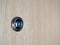 Lens peephole on wooden door
