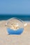 Lensball summer vacation landscape with starfish reflection. Travel and leisure concept.