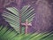 Lent Season,Holy Week and Good Friday concepts - image of wooden cross and heart shaped of palm leaf in purple vintage background.