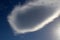 Lenticular cloud under a blue sky.
