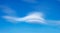 Lenticular clouds over blue sky