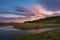 Lenticular Clouds at sunrise reflecting in a stream