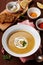 Lentil cream soup in a bowl with spices turmeric, paprika and garlic