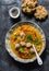 Lentil meatballs thick rich soup and corn flour cheese scones on a dark background, top view. Winter comfort food