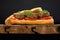 Lentil patty sandwich with tomato and carrot greens in old wooden board