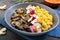 Lentil porridge with mushrooms, radish in a bowl on a dark background. Dietary, lean menu. Vegetarian dish