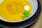 Lentil soup in a ceramic white bowl on a golden background