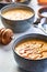 Lentil turkish yellow-coloured cream soup in a grey bowl. The second bowl is on the background. 45 angle view