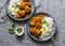 Lentils vegetarian roasted meatballs with curry sauce and rice - healthy lunch on grey background, top view.