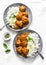 Lentils vegetarian roasted meatballs with curry sauce and rice - healthy lunch on light background, top view.