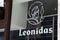 Leonidas logo brand and sign text wall windows facade shop entrance of Belgian