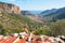 Leonidio village and impressive, tall, red limestone walls as seen from Aresos climbing sector, a climbing crag with great view.