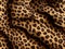 Leopard black and brown spotted print, looks like plush material. Generative AI