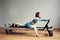 Leotard workout pilates training. athletic pilates reformer exercises. pilates machine equipment. young asian woman