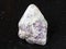 Lepidolite on polished quartz stone on dark