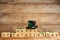 Leprechaun hat, clover leaves and wooden cubes with words Happy St Patrick`s Day on table, space for text