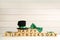 Leprechaun hat, green bow tie and wooden cubes with words Happy St Patrick`s Day on white table, space for text