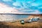 Lerissos, Greece, 25/06/2019: Motorhome vehicles parked on the beach with beautiful panoramic view on the bay and cloudy colorful