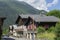 Les Houches, France - July 19, 2021: Town with old wooden houses along the main road with Alps in the distance