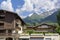 Les Houches, France - July 19, 2021: Town with wooden houses along the main road with Alps in the distance