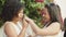 Lesbian couple putting rings on each other fingers at wedding