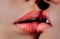 Lesbian love close up. Woman kiss. Sensual lips together. Wet girl mouth. Lip balm, cosmetics. Gentle kiss on a date