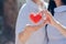 Lesbian lovers holding heart symbols to show love for each other on the bright morning of Valentine`s Day. LGBT couples are Asian