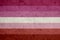 lesbian pride flag painted on grunge wall background, closeup. LGBTQ concept