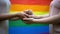 Lesbians holding hands, rainbow flag on background, lgbt rights and togetherness