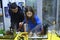 Lesson of aquarium husbandry. Girl arranging decoration in an empty aquarium, male teacher watching