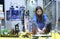 Lesson of aquarium husbandry. Girl pupil arranging decorations in an empty aquarium