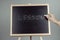 Lesson written in white chalk on a black chalkboard