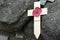 Lest we forget - Remembrance poppy on a wooden cross symbol of the first World War WOI at old trenches near Ypres Belgium