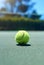 Let the games begin. Cropped shot of a tennis ball on an empty court during the day.