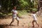 Let the games begin. a young father and son playing with branches on a camping trip.