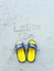 Let go word on the beach and yellow sandal