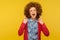 Let`s rock! Portrait of crazy woman with curly hair in casual outfit showing rock and roll sign and roaring angrily