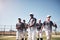 Let the world know the winners have arrived. a group of young men walking onto a baseball field.