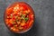 Letcho with tomatoes, peppers and carrots in glass bowl