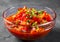 Letcho with tomatoes, peppers and carrots in glass bowl