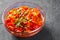 Letcho with tomatoes, peppers and carrots in glass bowl