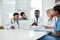 Lets delve deeper. a group of medical practitioners using a laptop during a meeting in a hospital boardroom.