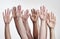 Lets develop our strengths together. a group of hands reaching up against a white background.