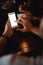 Lets invite more friends. Closeup of an unrecognizable man texting on his phone while being seated inside of a bar at