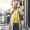 Lets meet up for coffee. a mature woman talking on her cellphone in the city.