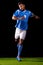 Lets play. Full length studio shot of a handsome young soccer player isolated on black.