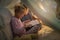 Lets read another one before bedtime. Cropped shot of siblings reading a story under a blanket fort at home.