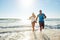 Lets runaway and be together forever. a happy young couple taking a walk on the beach.